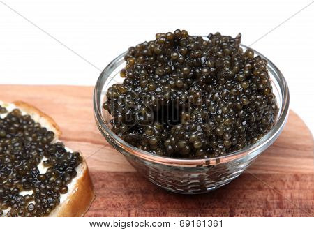 Black and red caviar in glass container
