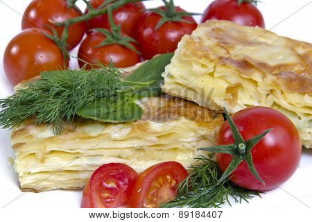 Turkish cheese pie borek with tomatoes isolated on white background