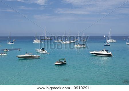 Many Boats Moored On The Blue And Green Sea