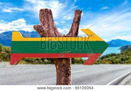 Lithuania Flag wooden sign with road background