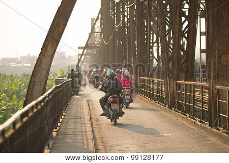 People ride motorbike in Long Bien bridge in Hanoi, Vietnam
