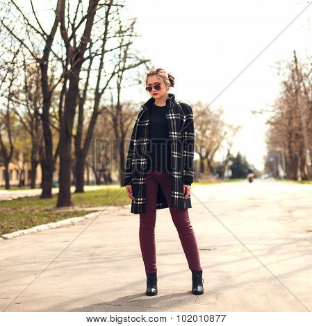 Beautiful Girl In Plaid Coat And Sunglasses Standing On A Strreet