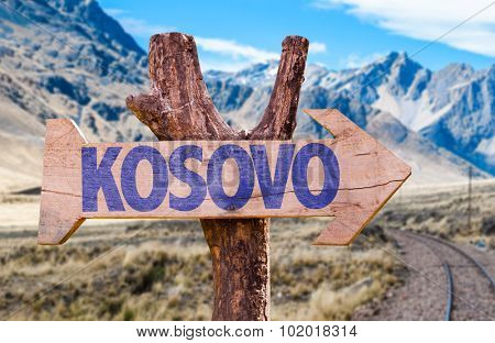 Kosovo wooden sign with Railways Track background