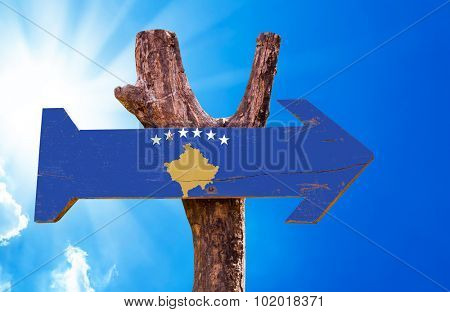 Kosovo Flag wooden sign with sky background