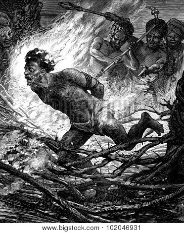 The torture of Papuan. This man is pushed in the midst of thorns inflamed, vintage engraved illustration. Journal des Voyage, Travel Journal, (1880-81).