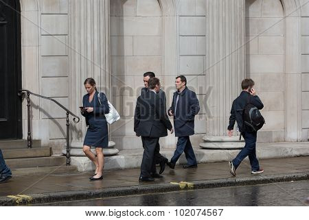 LONDON, UK - SEPTEMBER 17, 2015: Businessmen and businesswoman walking on the street against of Bank