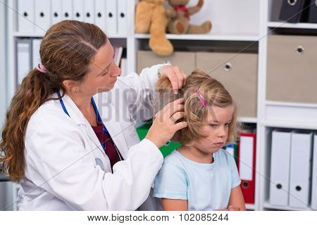 Female Pediatrician In White Lab Coat Examined Little Patient
