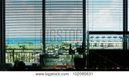Venetian blind lifted and blue sky