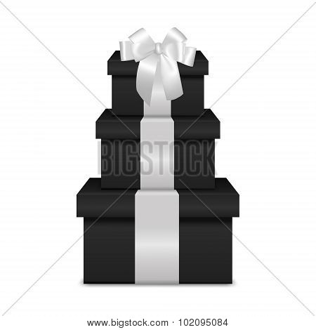 Stack of three realistic black gift boxes with white ribbon and bow
