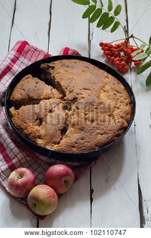 Cut Apple pie on wooden background