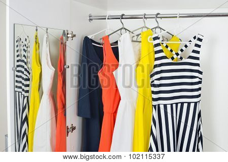 Series Of Bright Modern Fashion Women Dresses On Hangers