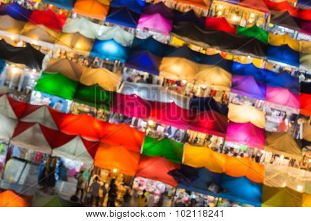 Abstract blurred bokeh, aerial view of flea market night time