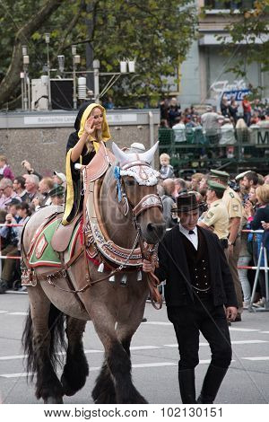 MUNICH, GERMANY - OCTOBER 19, 2015: A girl in the monk dress, which is the coat arm of Munich in tent owners and breweries parade of Oktoberfest