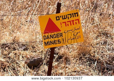Danger mines - old sign warning of land mines or minefield in the Golan Heights Israel.