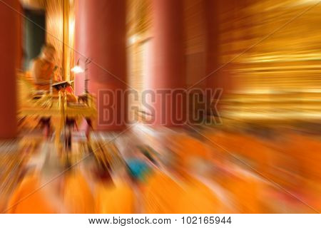 Blurred Zoom Of Thai Monk Worship In Temple