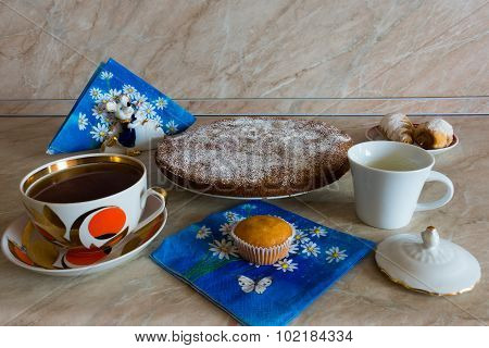 Coffee and cake are on the table.