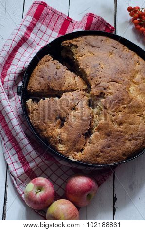 Cut Apple pie on wooden background
