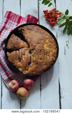 Cut Apple pie on wooden background