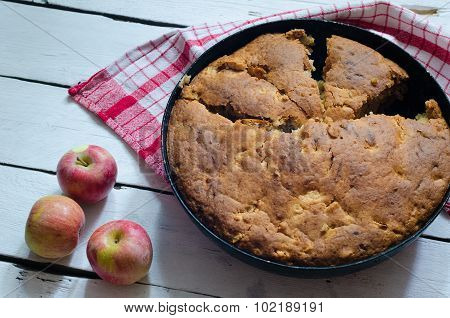 Cut Apple pie on wooden background