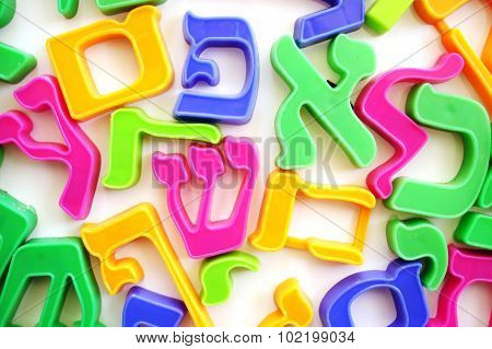 The Hebrew alphabet letters on a fridge which help children to spell.
