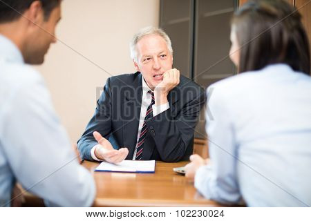 Businessman talking to a young couple