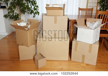Moving boxes in new house. New apartment background.