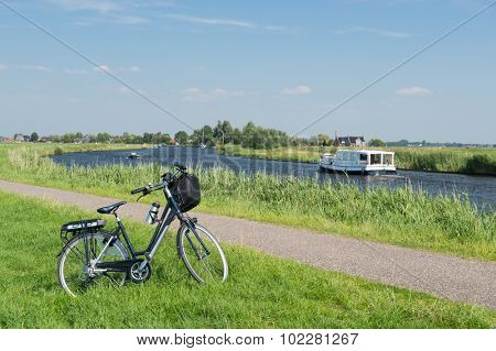 Typical Dutch landscape with river water and bike