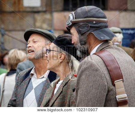 Elegant Lady And Two Older Men Wearing Tweed