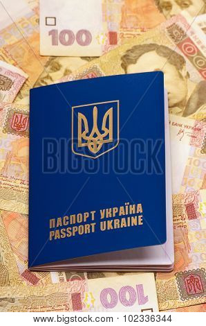 International Ukrainian passport on Hryvna banknotes background
