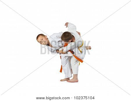 The athletes in judogi are performing throws
