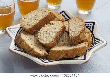 Dish with traditional Moroccan fekkas cookies with tea
