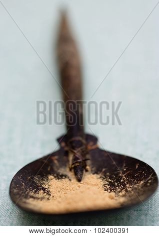 Ginger powder in wooden spoon