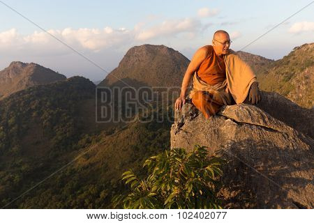 CHIANG DAO, THAILAND, JANUARY 05, 2015: A Buddhist monk master is meditating at the top of the Chiang Dao mount at dusk for the new year in Thailand.