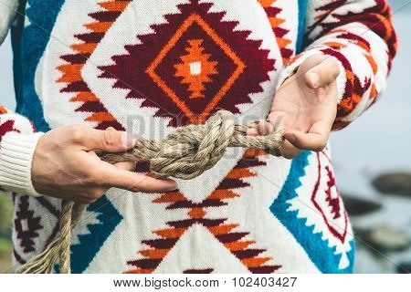 Man hands holding rope knot Travel Lifestyle survival concept
