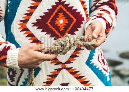 Man hands holding rope knot Travel Lifestyle survival concept