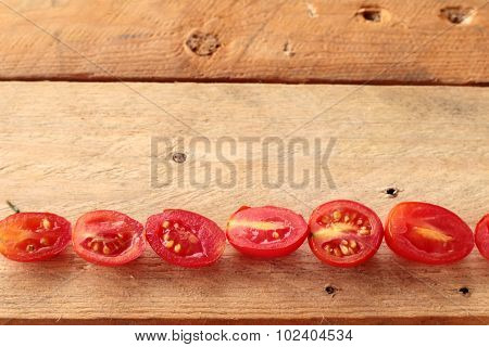 Tomatoes Sliced On Wood Background