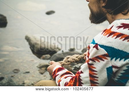 Man hands holding rope knot Travel Lifestyle survival concept