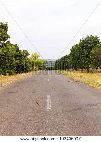Old Damaged Asphalt Road In Rural Ukraine. Rural Landscape.