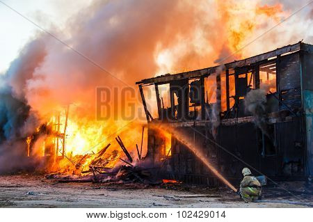 Fireman Extinguishes A Burning House