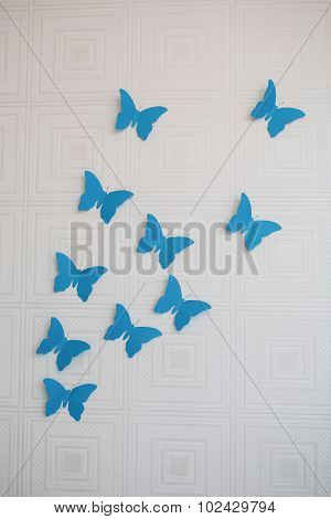 Blue paper butterfly on the wall