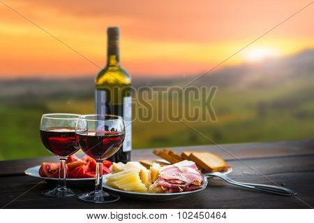 still life Red wine  ,cheese and prosciutto. Romantic dinner  outdoors