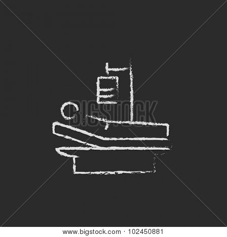 Patient lying on bed hand drawn in chalk on a blackboard vector white icon isolated on a black background.