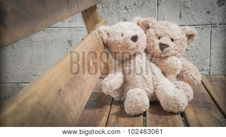 Teddybears on a park bench