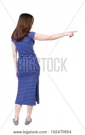 Back view of  pointing woman. beautiful girl. Rear view people collection.  backside view of person.  Isolated over white background. A girl in a long blue dress she saw something left.