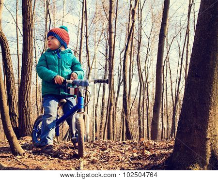 little boy on running bike outdoors, kids sport