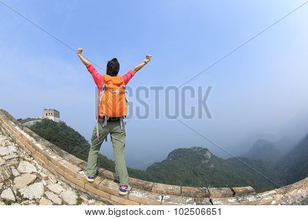 cheering hiking woman hiker open arms on chinese great wall