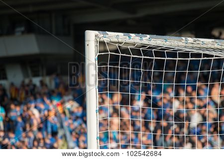 Goal post with soccer fans in the background