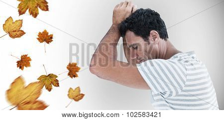 Upset man leaning on white background against autumn leaves pattern