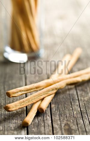 breadsticks grissini on old wooden table