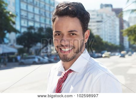 Laughing latin businessman in the city